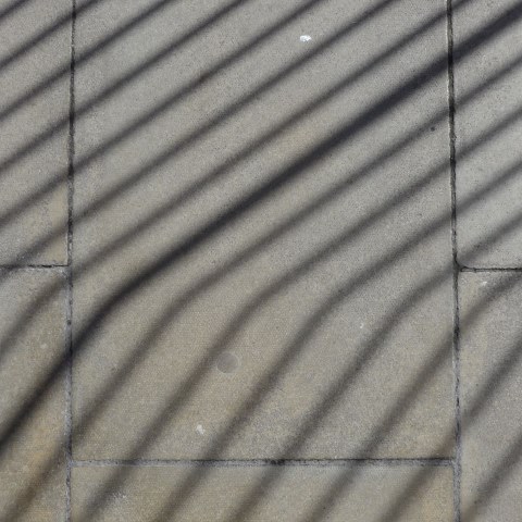 d10955: semi-abstract photo (shadow of railings on pavement, Scarborough) by Ewart Shaw