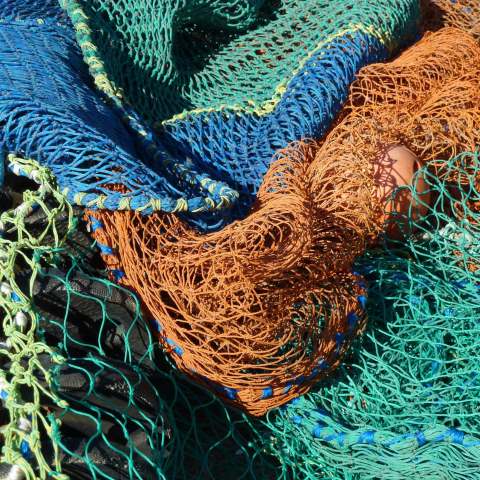 t00783: semi-abstract photo (fishing nets on quayside) by Ewart Shaw