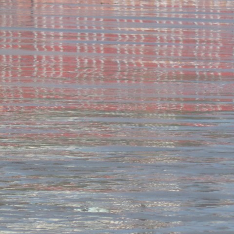 t10602: semi-abstract photo (red reflections on beach) by Ewart Shaw