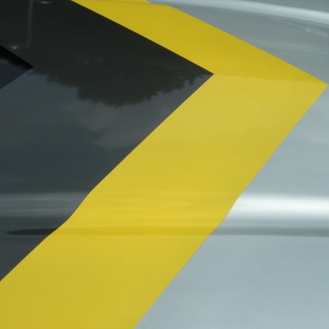 t30468: semi-abstract photo (black/yellow/silver car bonnet, Coventry MotoFest 2018) by Ewart Shaw