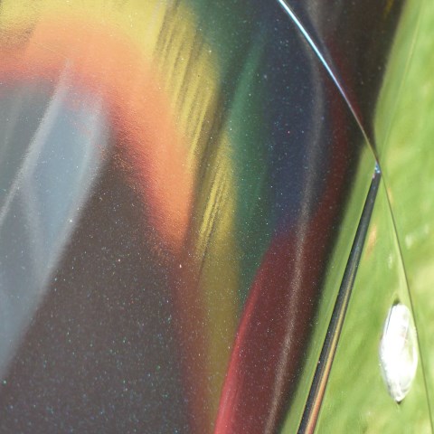 t30477: semi-abstract photo (pride flag reflected in car door, Coventry MotoFest 2018) by Ewart Shaw